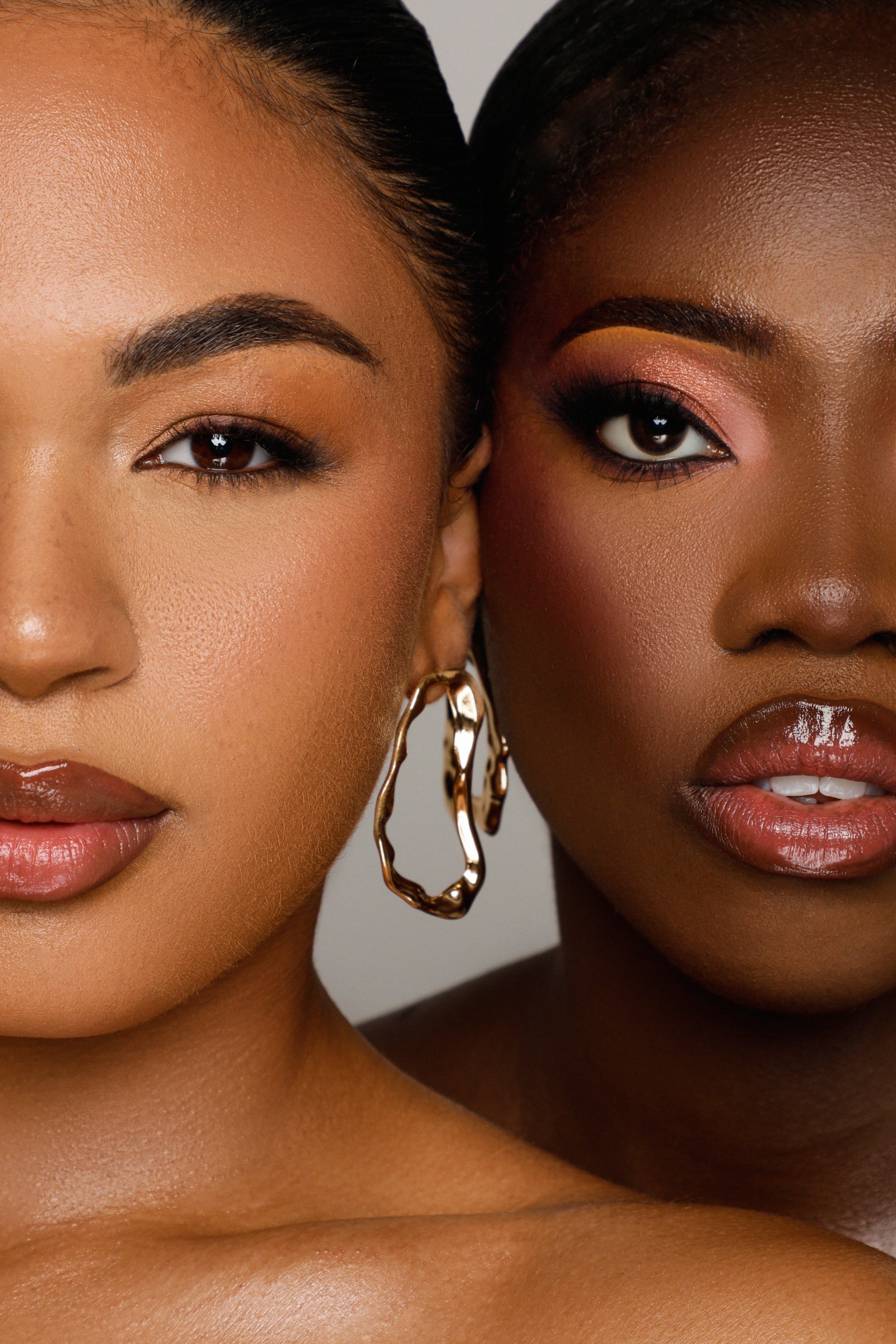 Two models wearing warm and cool toned glam eyeshadow looks using Shades of London palettes
