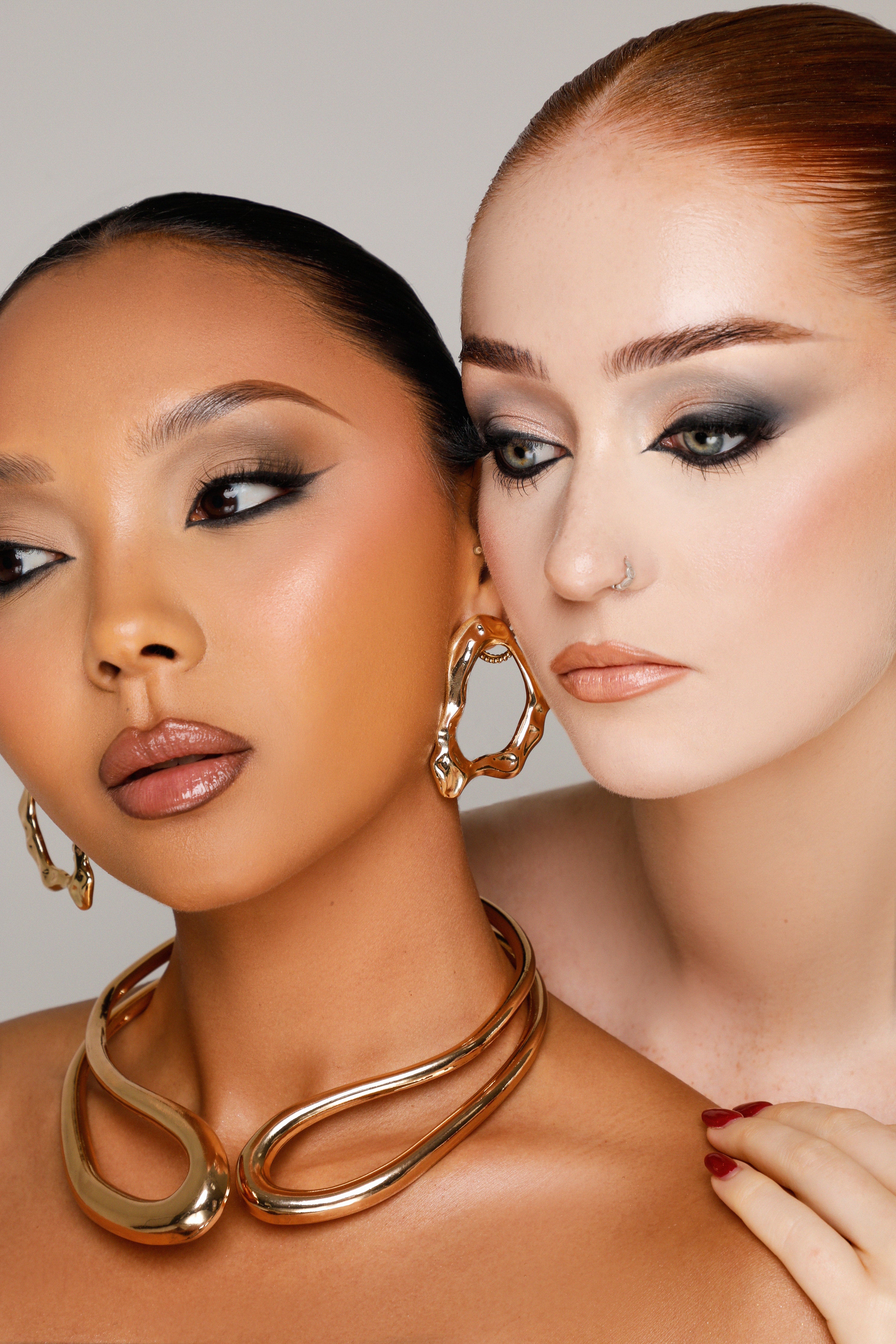 Two models wearing cool smokey eyes using Shades of London Shades 3 palette, silver and charcoal tones
